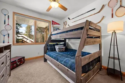 a bedroom with a bunk bed and a window at 102 Mountain Lodge Way in Winter Park