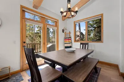 a dining room with a wooden table and chairs at 102 Mountain Lodge Way in Winter Park