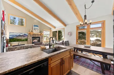 a kitchen with a sink and a living room at 102 Mountain Lodge Way in Winter Park