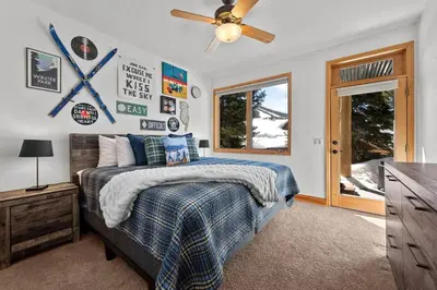 a bedroom with a bed and a ceiling fan at 102 Mountain Lodge Way in Winter Park