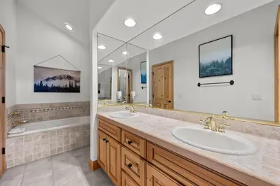 a bathroom with two sinks and a large mirror at 102 Mountain Lodge Way in Winter Park