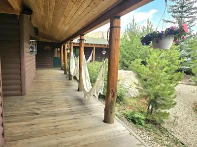 a porch with hammocks on a house at Columbine Charming Cabin, 1 block from the lake, in town, 5 min to RMNP in Grand Lake