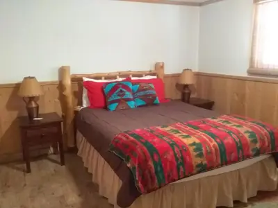 a bedroom with a bed with two night stands and two lamps at Colorado Cabin Adventure in Grand Lake