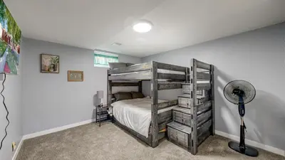 a bedroom with a bunk bed and a fan at Cozy Lower Affordable Apartment great for families in Arvada