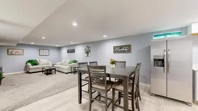 a kitchen and dining room with a table and a refrigerator at Cozy Lower Affordable Apartment great for families in Arvada
