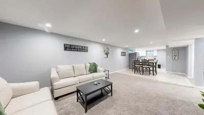 a living room with a white couch and a table at Cozy Lower Affordable Apartment great for families in Arvada
