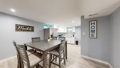 a dining room and kitchen with a table and chairs at Cozy Lower Affordable Apartment great for families in Arvada