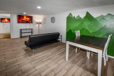 a room with a ping pong table and a couch at Cozy Mountain-Inspired Lower Unit in Denver in Denver