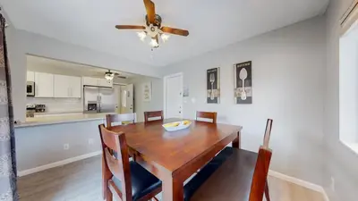 a dining room with a table and a ceiling fan at Bright & Cozy Upper Unit in Denver in Denver