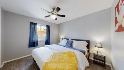 a bedroom with a bed and a ceiling fan at Bright & Cozy Upper Unit in Denver in Denver