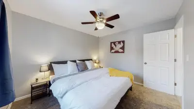 a bedroom with a bed with a ceiling fan at Bright & Cozy Upper Unit in Denver in Denver