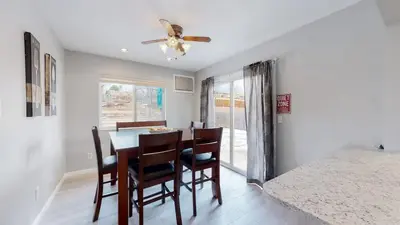 a dining room with a table and chairs and a ceiling fan at Bright & Cozy Upper Unit in Denver in Denver
