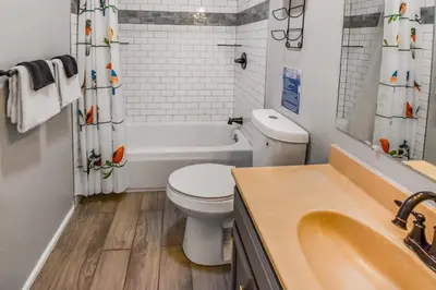 a white bathroom with a toilet and a sink at Spacious Studio with King Bed & Fast WiFi in Denver