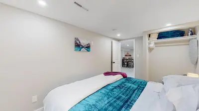 a white room with a bed in a room at Modern & Updated Unit in Prime Location in Denver