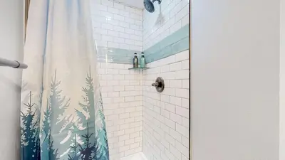 a bathroom with a shower with a shower curtain at Modern & Updated Unit in Prime Location in Denver