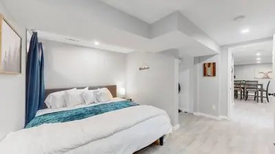 a bedroom with a large bed and a dining room at Modern & Updated Unit in Prime Location in Denver