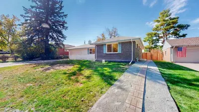 a house with a flag on the side of it at Modern & Updated Unit in Prime Location in Denver