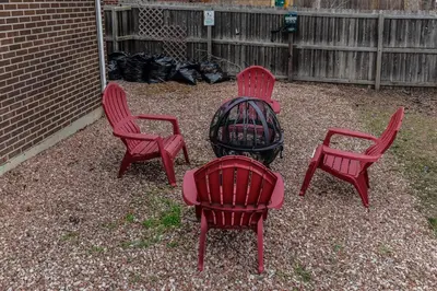 a group of four red chairs around a fire pit at Enchanting Upper Unit with City Charm in Denver