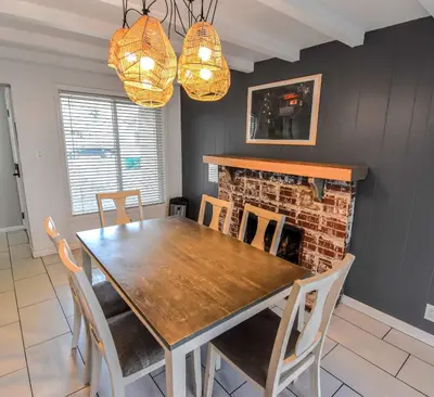 a dining room with a table and chairs and a fireplace at Enchanting Upper Unit with City Charm in Denver