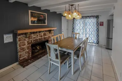 a dining room with a table and a fireplace at Enchanting Upper Unit with City Charm in Denver