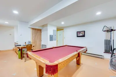 a pool table in the middle of a room at 4 Mi to RMNP Allenspark Cabin with Wraparound Deck! in Allenspark