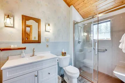 a bathroom with a toilet sink and a shower at 4 Mi to RMNP Allenspark Cabin with Wraparound Deck! in Allenspark