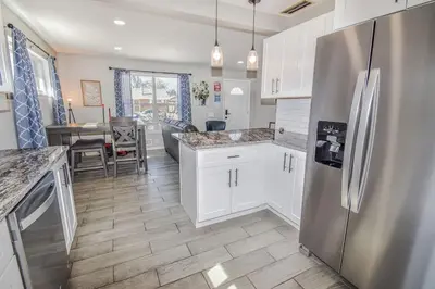 a kitchen with a stainless steel refrigerator and a table at Awesome Two Bedroom Family Upper Unit in Denver in Denver