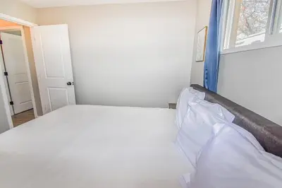 a bedroom with a bed and a window at Awesome Two Bedroom Family Upper Unit in Denver in Denver