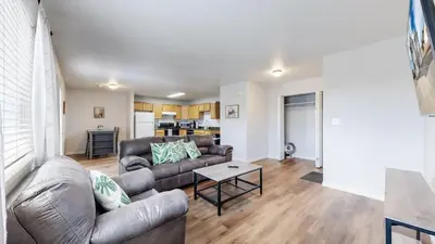 a living room with a couch and a table at Great Two King Bed Rooms Near Airport Ideal Stay in Brighton