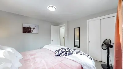 a bedroom with a bed and a window and a fan at Arvada Private Family Home with Two King Beds in Arvada