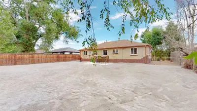 a house with a large driveway in front of it at Arvada Private Family Home with Two King Beds in Arvada