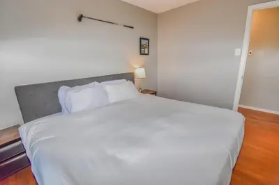a bedroom with a large white bed with white pillows at Family Home with Large Yard & Golf Theme Near Rail in Denver
