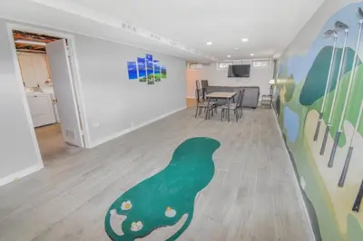 a room with a green bird painted on the wall at Family Home with Large Yard & Golf Theme Near Rail in Denver