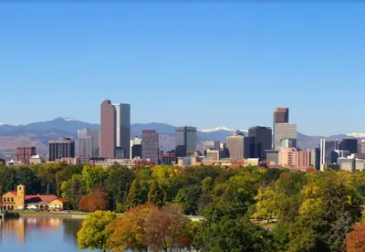 a cityscape of a city with a lake and buildings at Family Home with Large Yard & Golf Theme Near Rail in Denver