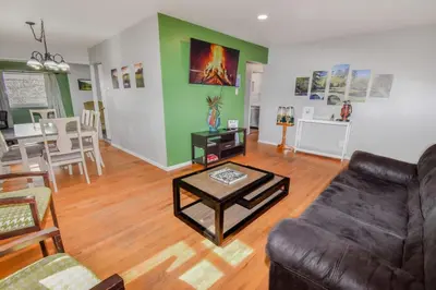 a living room with a couch and a table at Family Home with Large Yard & Golf Theme Near Rail in Denver