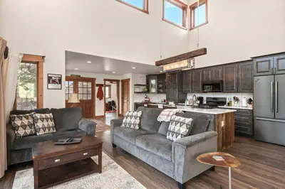 a living room with two couches and a kitchen at 34 Acre Escape Games Hiking Pool Table Bicycles in Black Hawk