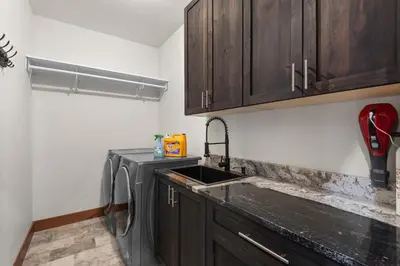 a kitchen with a sink and wooden cabinets at 34 Acre Escape Games Hiking Pool Table Bicycles in Black Hawk