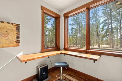 a home office with a desk and two windows at 34 Acre Escape Games Hiking Pool Table Bicycles in Black Hawk