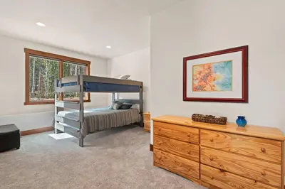a bedroom with a bunk bed and a wooden dresser at 34 Acre Escape Games Hiking Pool Table Bicycles in Black Hawk