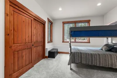 a bedroom with a bed and a large wooden door at 34 Acre Escape Games Hiking Pool Table Bicycles in Black Hawk