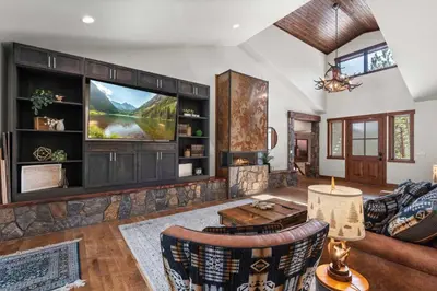 a living room with a couch and a tv at 34 Acre Escape Games Hiking Pool Table Bicycles in Black Hawk