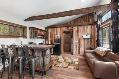 a kitchen and living room with a couch and a table at 34 Acre Escape Games Hiking Pool Table Bicycles in Black Hawk