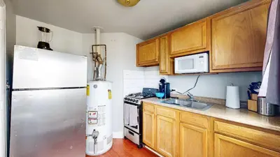 a kitchen with a refrigerator and a sink at Cool Stay Near Rapids Stadium Ideal for Sports Fans in Commerce City