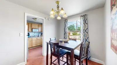 a kitchen and dining room with a table and chairs at Cool Stay Near Rapids Stadium Ideal for Sports Fans in Commerce City