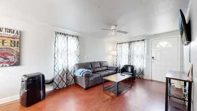 a living room with a couch and a table at Cool Stay Near Rapids Stadium Ideal for Sports Fans in Commerce City