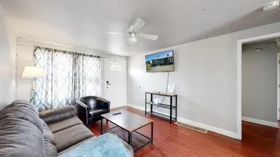 a living room with a couch and a table at Cool Stay Near Rapids Stadium Ideal for Sports Fans in Commerce City