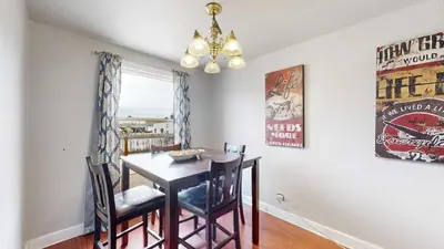a dining room with a table and chairs and a chandelier at Cool Stay Near Rapids Stadium Ideal for Sports Fans in Commerce City