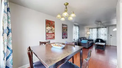 a dining room with a table and a couch at Cool Stay Near Rapids Stadium Ideal for Sports Fans in Commerce City