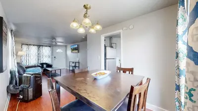 a dining room with a table with chairs and a dining room at Cool Stay Near Rapids Stadium Ideal for Sports Fans in Commerce City
