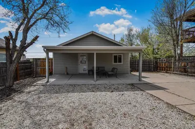 a small house with a patio and a fence at Fun and Affordable Dual Bedroom Lower Unit in Vibrant Denver in Denver